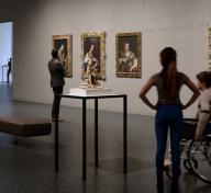 Visitors in a gallery with European painting and sculpture
