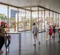 Rendering of light-filled gallery with visitors and art with view to the outside