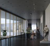 Visitor-filled gallery with sculptures displayed 