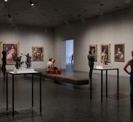 Interior view of gallery with visitors and European painting and sculpture