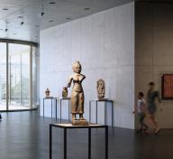 Interior view of gallery with sculptures and visitors