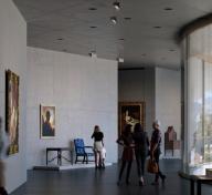 Visitors in sun-lit galleries with art on view