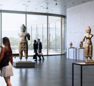 Visitors in an airy gallery with sculptures